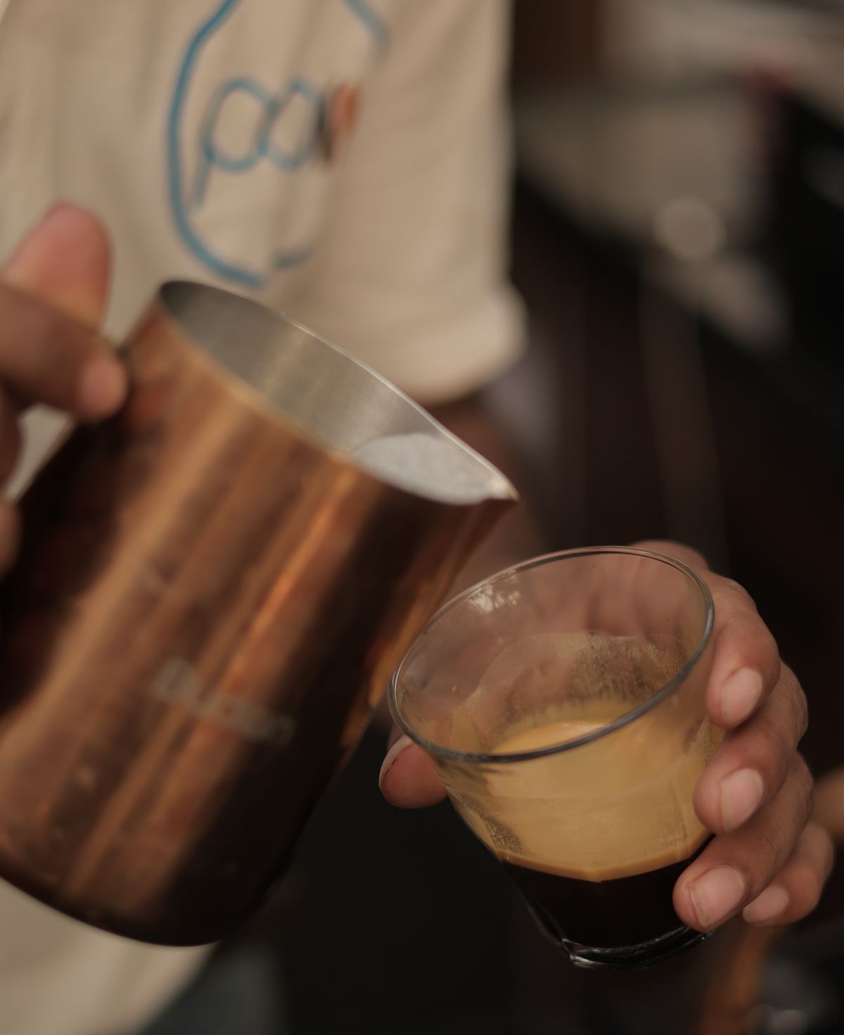 PAS barista pouring espresso
